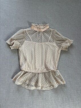 Story On polka dot chiffon ruffle top.